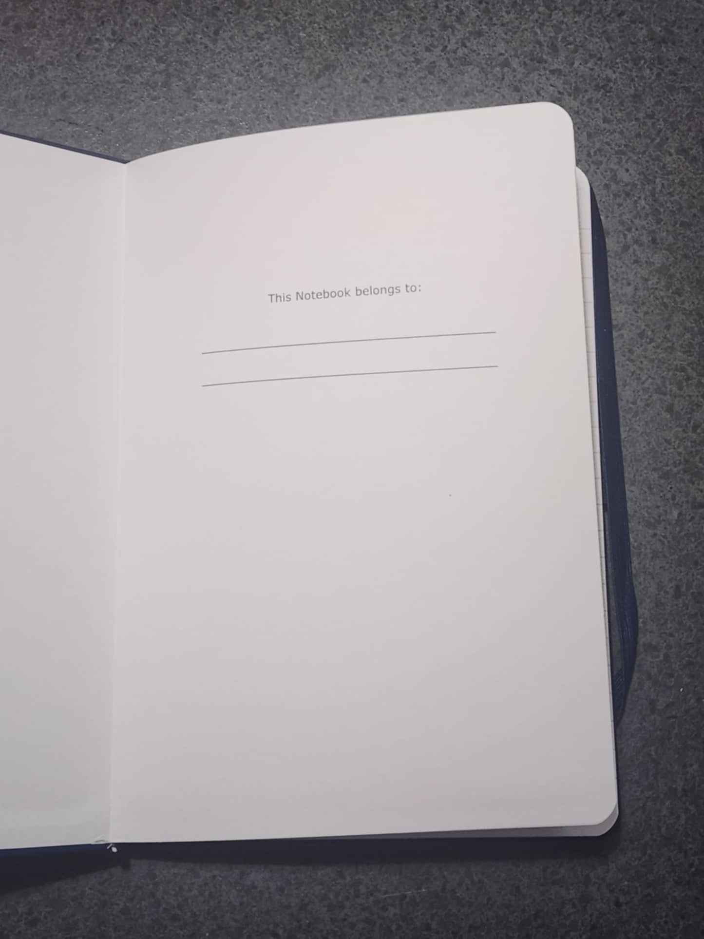 Open notebook with a blank page on a gray background