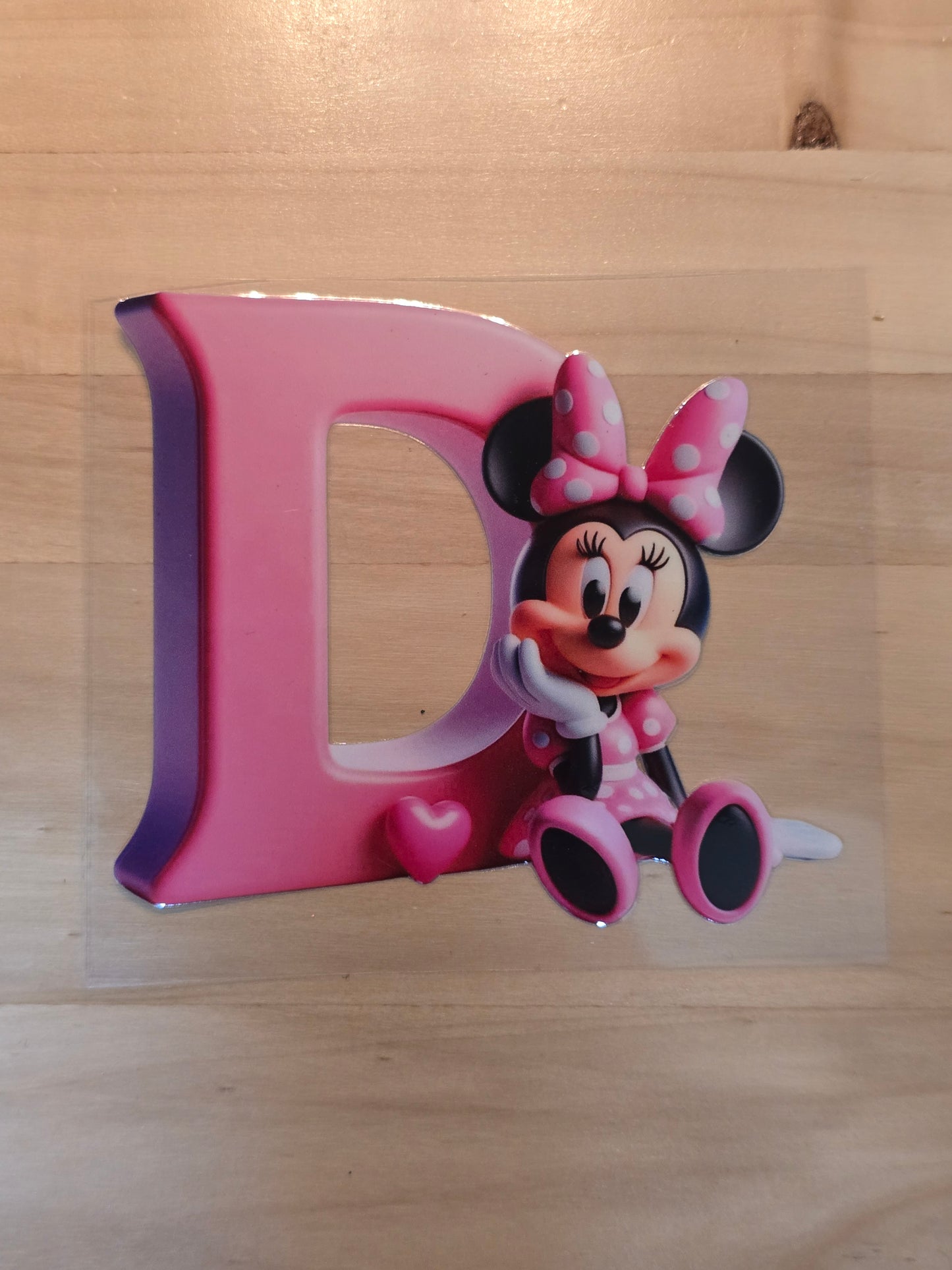 Pink Letter D with Minnie Mouse sat beside it